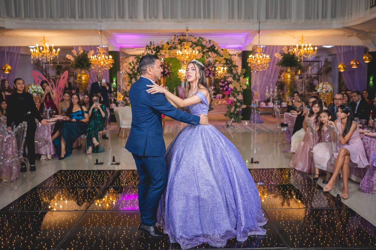 A memorable father-daughter dance at an elegant quinceañera celebration with a vibrant ballroom setting.